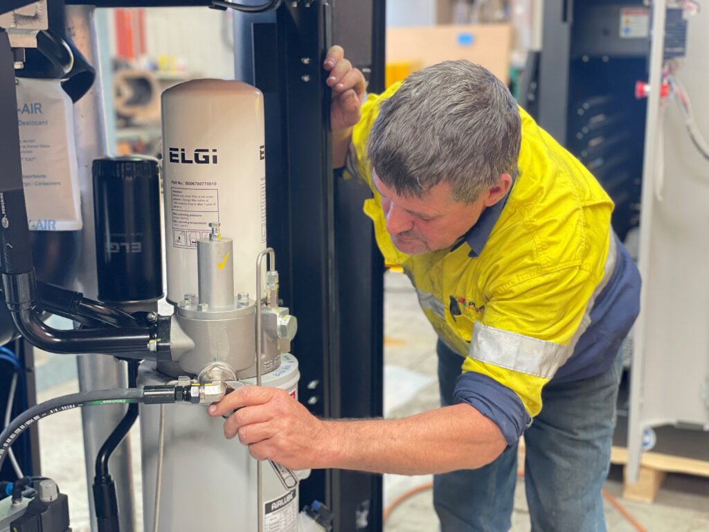 Pneumatic Engineering technician working on an ELGi compressor